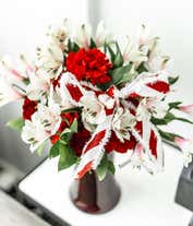 Alternative image 1 for Red carnations and white alstroemeria in a red vase with holiday bow