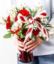 Alternative image 2 for Red carnations and white alstroemeria in a red vase with holiday bow