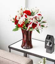 Alternative image 3 for Red carnations and white alstroemeria in a red vase with holiday bow