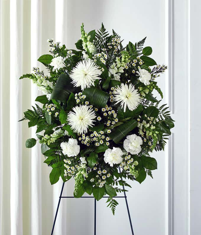 Funeral flowers with white lilies and white mums in standing spray