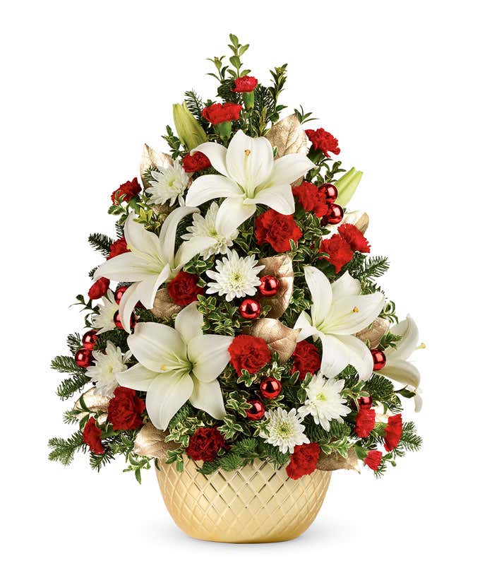 A flower Christmas tree with white and red flowers in a gold vase