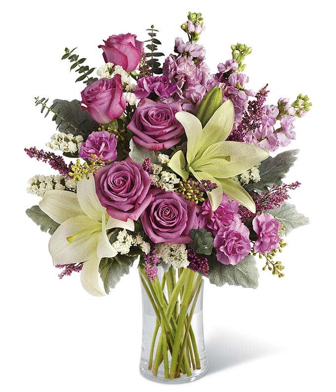 Purple roses, white lilies and mini pink carnations