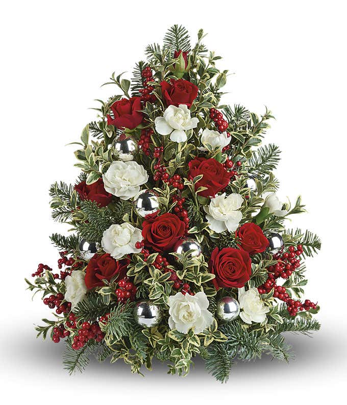 Mini Holiday Tree with mini white roses, mini red roses, and floral greenery with silver ornaments and red berry picks