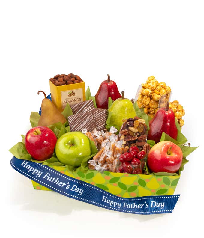 Father's Day gift basket filled with fresh apples, pears, and red pears, alongside caramel popcorn, roasted almonds, assorted caramels, trail mix, and chocolate-covered cherries, arranged in a green patterned box with a blue Happy Fathers Day ribbon.