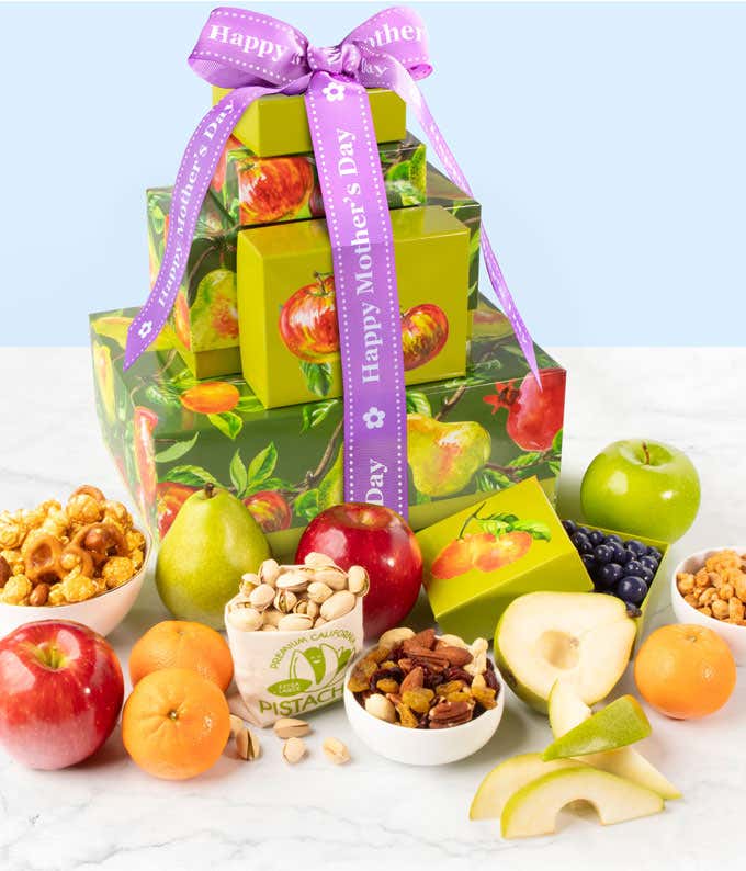 Gift tower with red & green apples, mandarins, butter toffee peanuts, green pear, chocolate blueberries, and caramel popcorn with a Happy Mother's Day ribbon