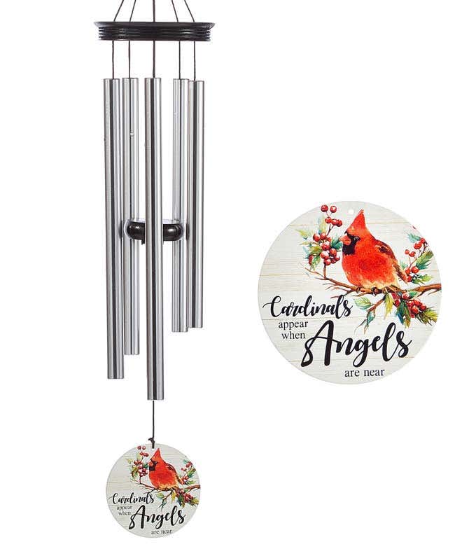 A windchime with metal rods and a wooden accents and heart shaped sail. White sail reads cardinals appear when angels are near with a cardinal on a holly branch.