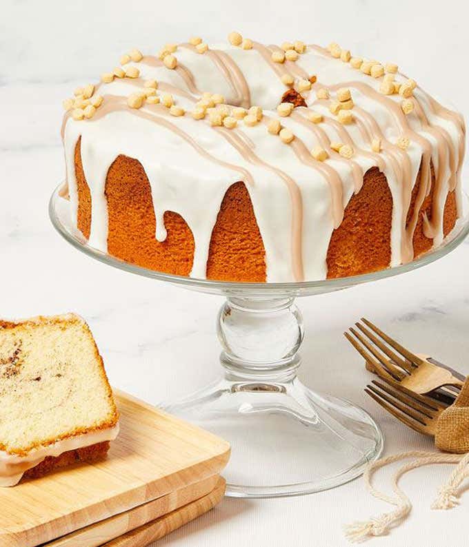 An iced cinnamon cake topped with a delightful cinnamon drizzle and candies.