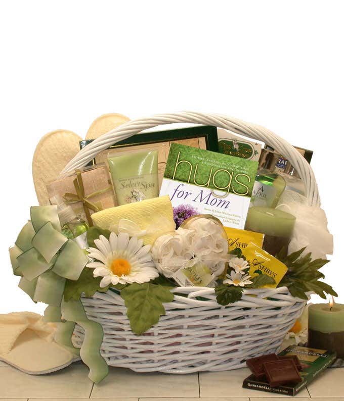Image of a Mother's Day gift basket containing a Hugs For Mom Book, Cucumber Melon Body Spray, Lotion, Body Wash, Bath Fizzies, Facial Towel, Waffle Slippers, Lemon Tea, Loofah, Scented Drawer Sachet, Cucumber Melon Candle, Ghirardelli Chocolate Bar, Choc
