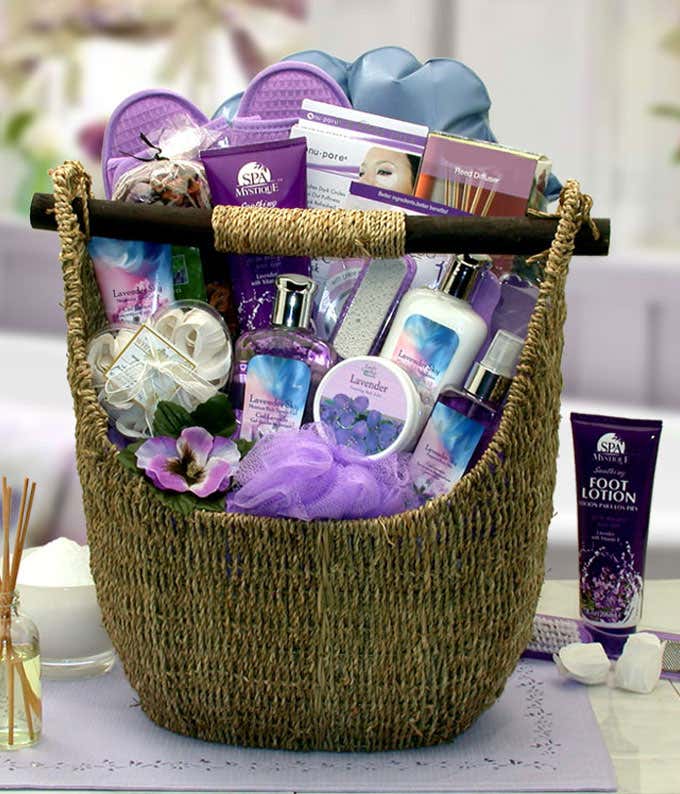 Lavender-themed spa gift basket with lotions, body wash, foot care products, and bath accessories in a woven basket.