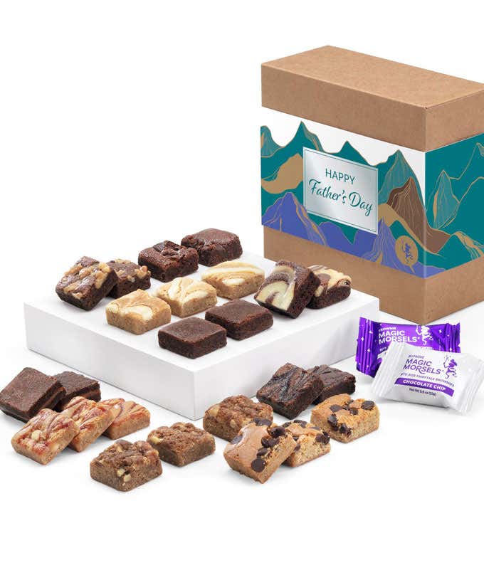 The image displays a box labeled 'Happy Father's Day' with a mountain design, filled with assorted brownies and cookies. The treats are arranged in rows on white trays, showcasing various flavors and toppings. Two Magic Morsels packets are also visible