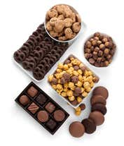 Alternative image 1 for A gift set overflowing with chocolate indulgences including chocolate-covered pretzels, mini cookies, caramel popcorn, chocolate and peanut butter buckeyes, six chocolate-covered Oreos, and a box of assorted truffles for a luxurious touch.