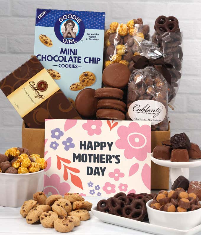 A box filled with chocolate-covered pretzels, mini chocolate chip cookies, caramel popcorn, assorted chocolates, mini buckeyes, chocolate covered Oreos, and a Happy Mother's Day card.