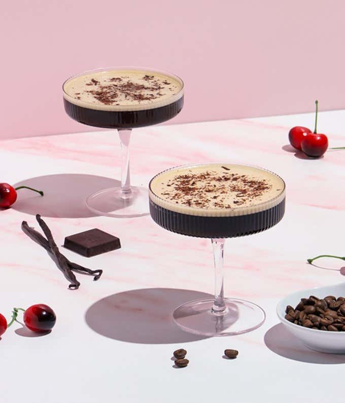 The cocktail kit contains a 4 oz. bottle of cherry-vanilla syrup, a 3.7mL bottle of cocoa bitters, an 11oz. can of cold brew coffee, a square of dark chocolate, and a recipe card.