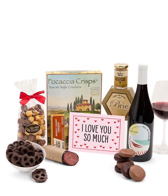 A gift featuring Hill & Harbor Pinot Noir & Chardonnay, smoky sharp cheddar, Brie cheese, focaccia crisps, summer sausage, stone-ground mustard, chocolate-covered pretzels, chocolate-dipped cookies, caramel popcorn, and an 'I Love You So Much' message.