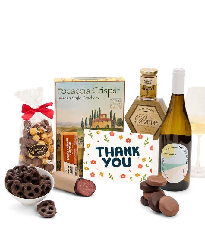 A gift set featuring a bottle of California Chardonnay, focaccia crisps, two cheeses, mustard, summer sausage, caramel popcorn, chocolate pretzels, six chocolate-covered Oreos and a Thank You card to complete the gourmet experience.