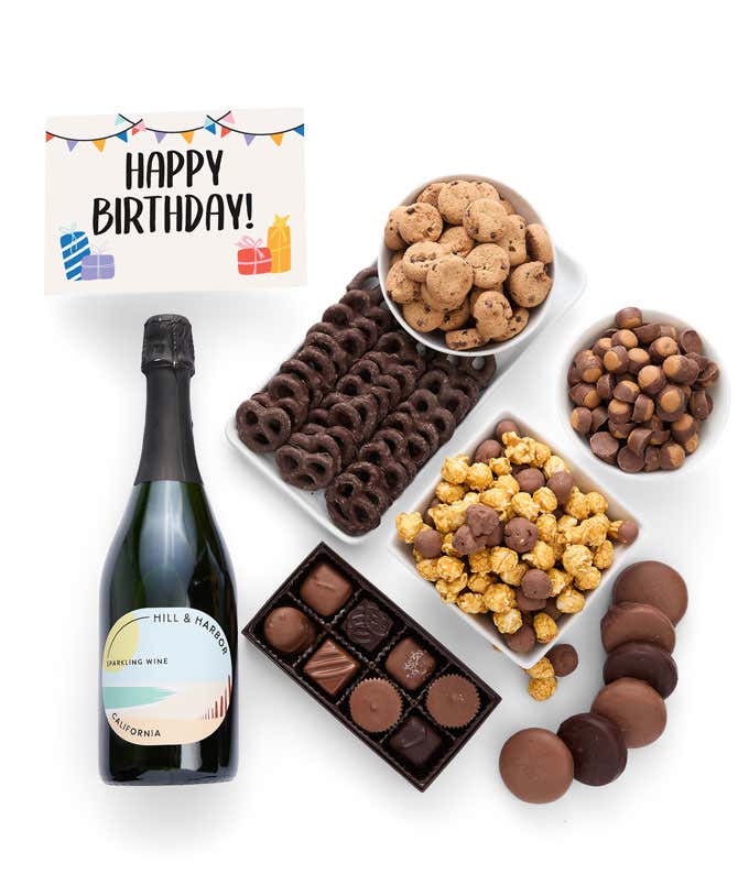 A gift set featuring a bottle of California Sparkling Wine paired with chocolate-covered pretzels, mini cookies, caramel popcorn, chocolate peanut butter buckeyes, 6 chocolate-covered Oreos, a box of assorted chocolates, and I Love You card.