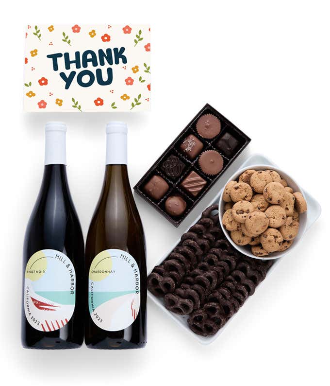 a gift box full of treats with a Thank You message card.  Contents include: two bottles of California wine - Chardonnay and Pinot Noir, milk chocolate pretzel, a box of mini chocolate chip cookies, and a 4-ounce box of assorted chocolates.