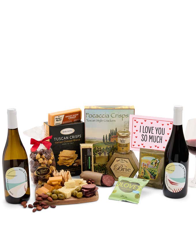 A luxurious gift box with a bottle of Hill & Harbor Pinot Noir, three cheeses, gourmet crackers, summer sausage, marinated olives, smoked almonds, stone-ground mustard, chocolate-covered, and a pink 'I Love You So Much' card