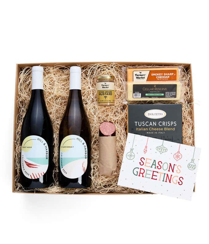 A gift box with two bottles of California wine - Pinot Noir and Sparkling Wine, two types of cheese, crackers, stone-ground mustard, and a summer sausage.