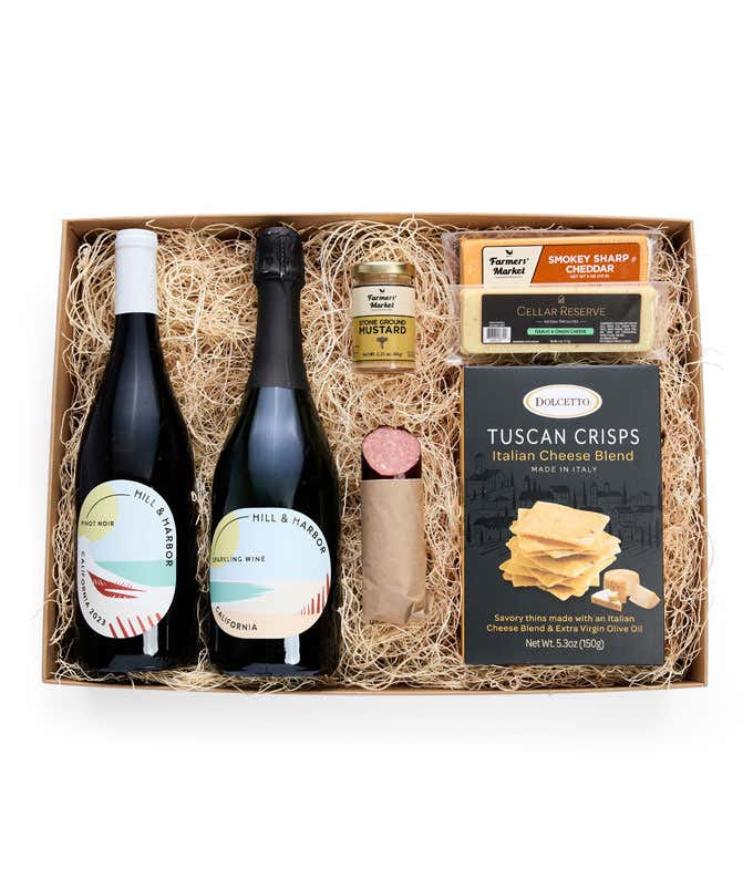 A gift box with two bottles of California wine - Pinot Noir and Sparkling Wine, two types of cheese, crackers, stone-ground mustard, and a summer sausage.