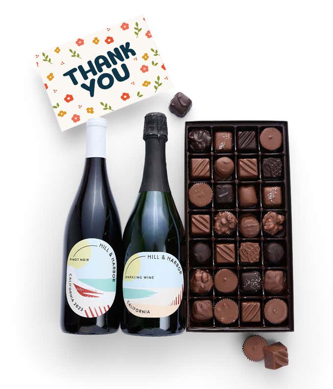 A gift box containing two bottles of California Wine - Pinot Noir & Sparkling Wine, a 1 lb box of 28 assorted gourmet chocolates in a grid, and a Thank You card.   A refined combination perfect to show your appreciation.