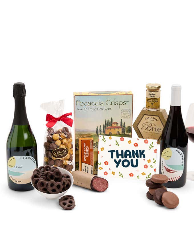 A gift set featuring 2 bottles of Hill & Harbor wine - red and sparkling, focaccia crisps, two cheeses, mustard, summer sausage, caramel popcorn, chocolate pretzels, six chocolate-covered Oreos and a Thank You card to complete the gourmet experience.