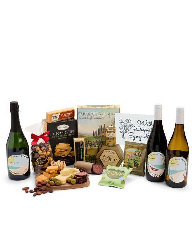 A wine and cheese gift set featuring 3 bottles of Hill & Harbor wine - red, white and sparkling. Includes a variety of gourmet cheeses, crackers, olives, almonds, sausage, and condiments finished with a Sympathy Card.