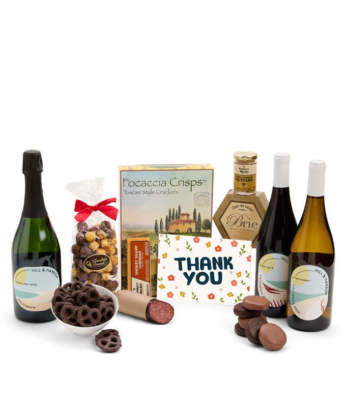 A gift set with a trio of California wines - red, white, and sparkling, focaccia crisps, two cheeses, mustard, summer sausage, caramel popcorn, chocolate pretzels, six chocolate-covered Oreos and a Thank You card to complete the gourmet experience.