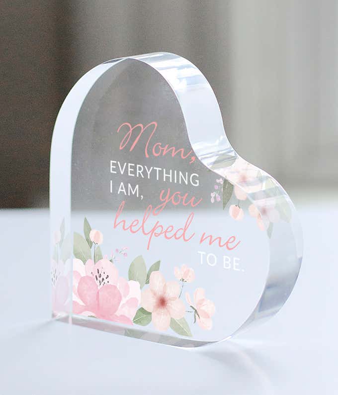 An acrylic heart with pink flowers, and a quote that reads: Mom, everything I am, you helped me to be