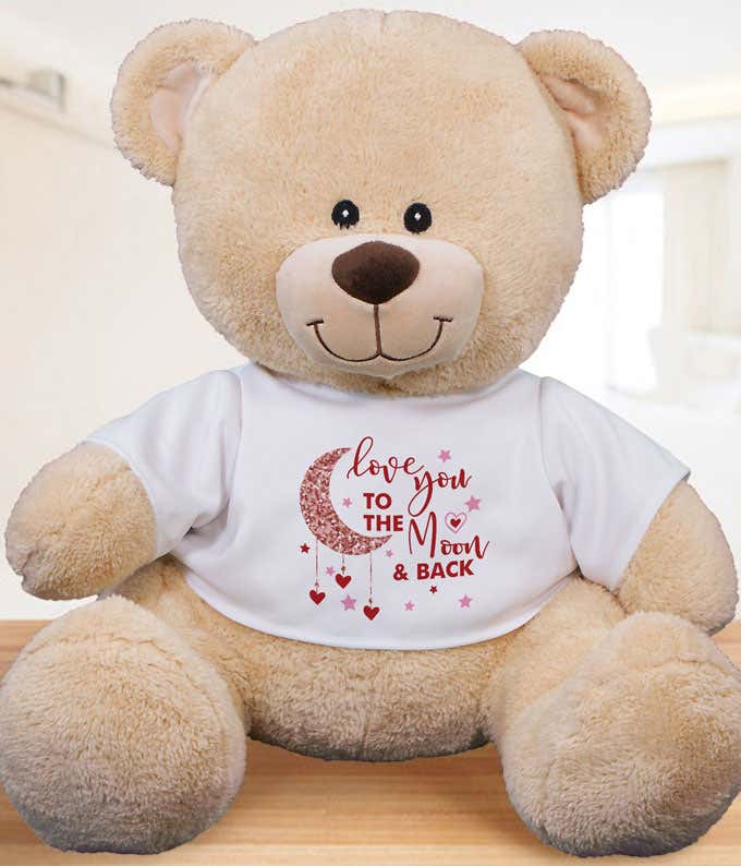 Beige stuffed teddy bear with a white t-shirt that reads love you to the moon and back