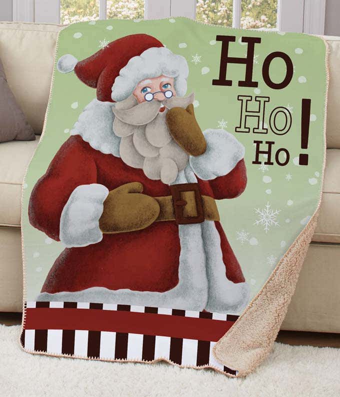 Large sherpa blanket with a giant Santa featured on it, and the text Ho Ho Ho!