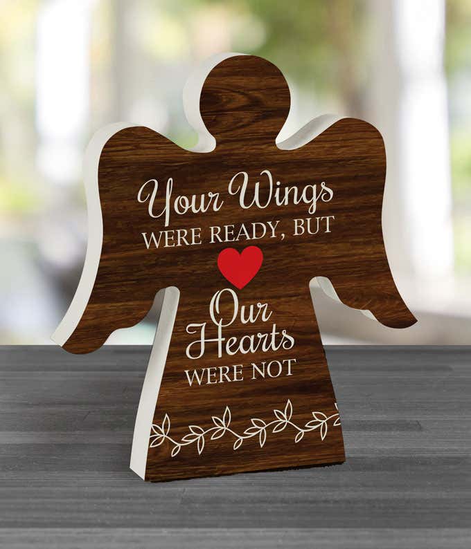 Angel cutout figure with wood grain design and the quote 