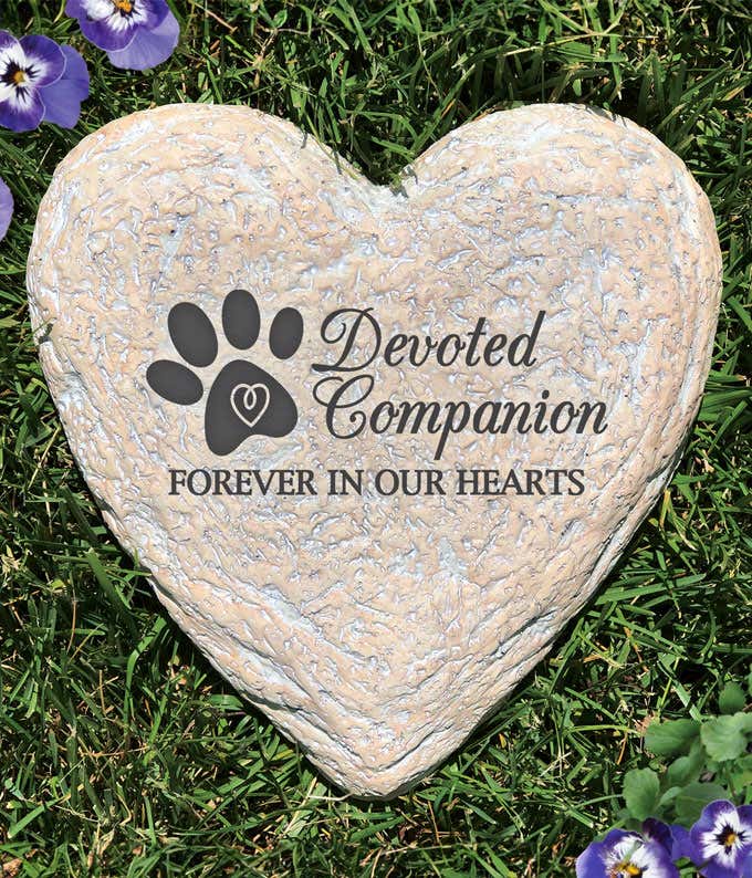 Heart-shaped pet memorial garden stone with paw print and inscription Devoted Companion, Forever in Our Hearts.