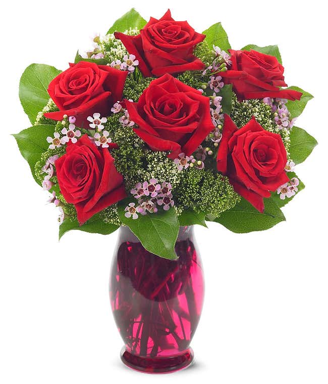 Flower arrangement with red roses in colorful vase