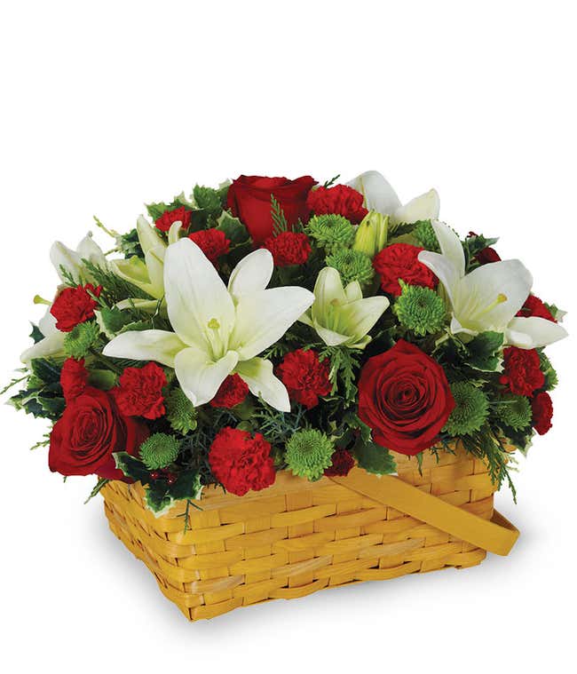 Red roses, white lilies and carnations in a basket for Christmas
