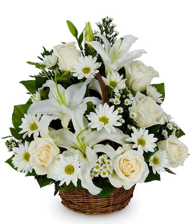White lilies, white roses and white daisies in a basket