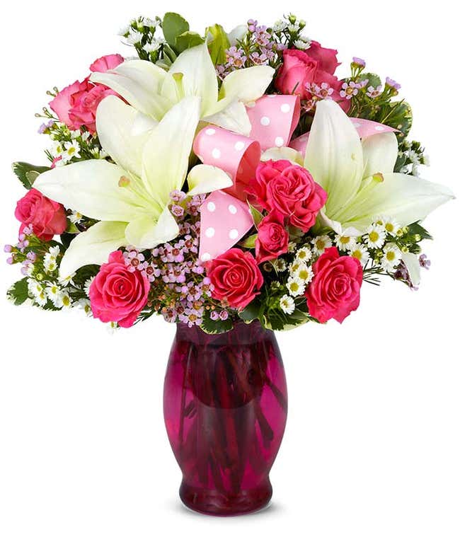 Pink spray roses, white lilies and pink wax flower 