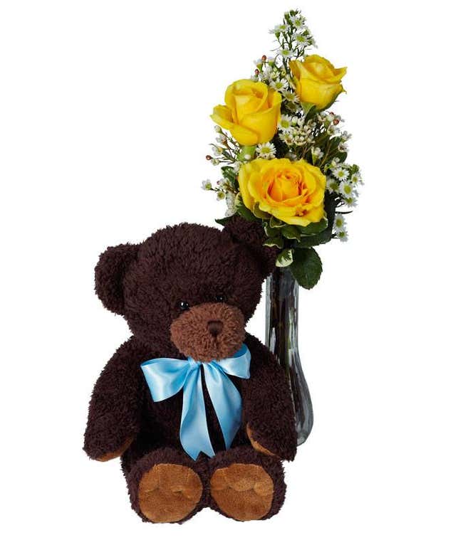 Yellow roses in vase with teddy bear