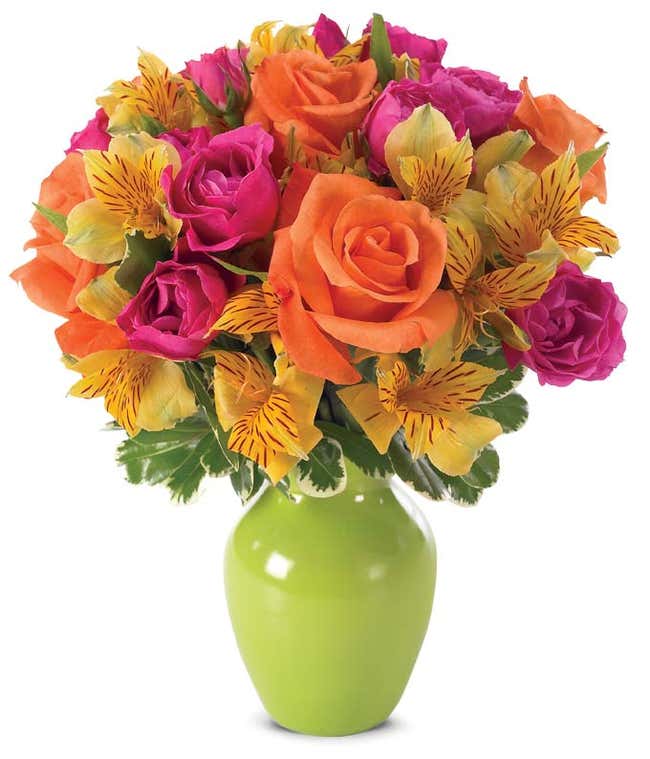 Orange roses, pink spray roses and yellow alstoermeria in a green vase