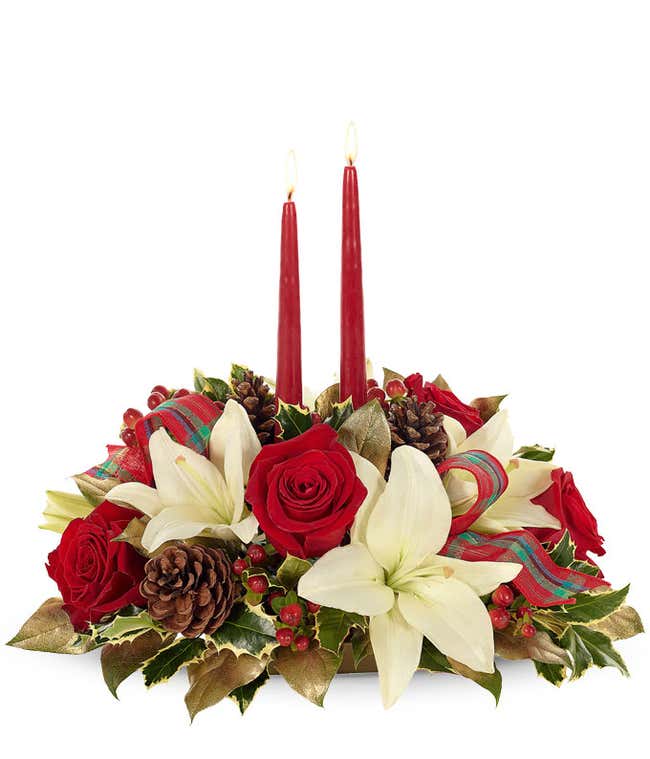 white lilies, red roses and pinecone with red candles centerpiece