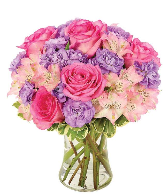 Pink roses with purple flowers in a playful bouquet