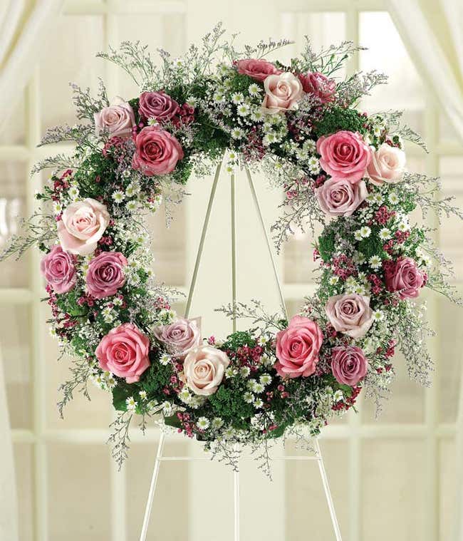 Pink roses, purple roses and white roses in funeral wreath