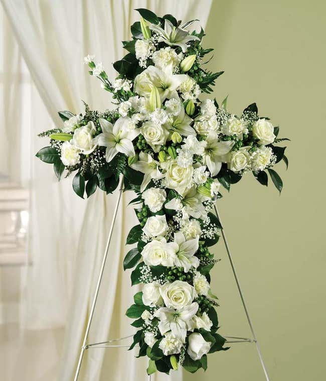 Sympathy standing spray with white roses, lilies and carnations