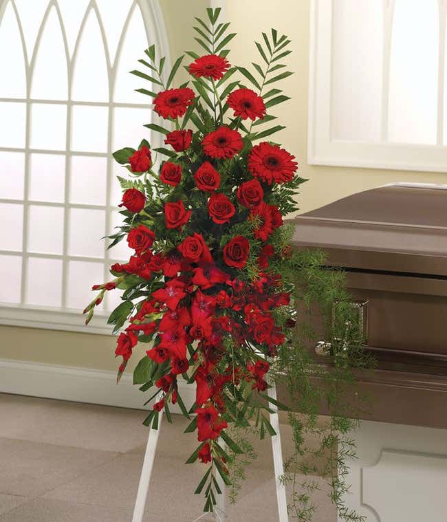 Standing spray of red roses, alstroemeria, and gladiolus