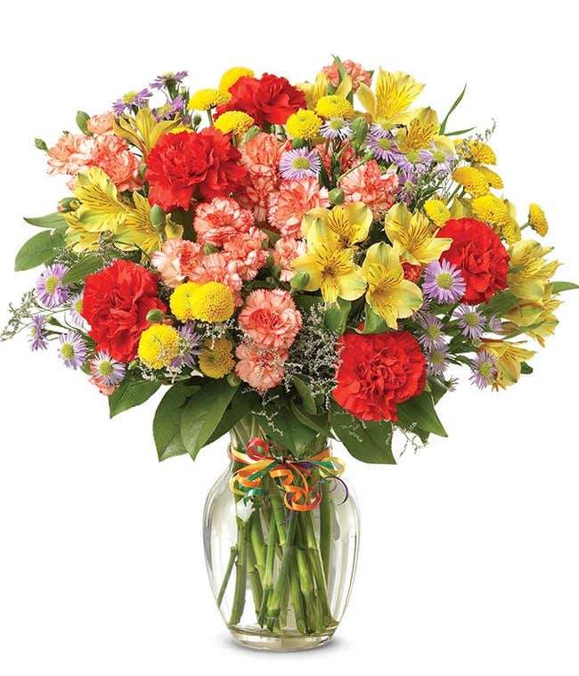 Red carnations, yellow alstroemeria and poms in a celebration bouquet
