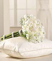 White roses, white tulips and orchids arranged in a bridesmaid bouquet
