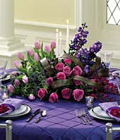 Purple roses and purple tulip in floral centerpiece