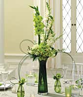 Green &amp; white roses and orchids in a centerpiece
