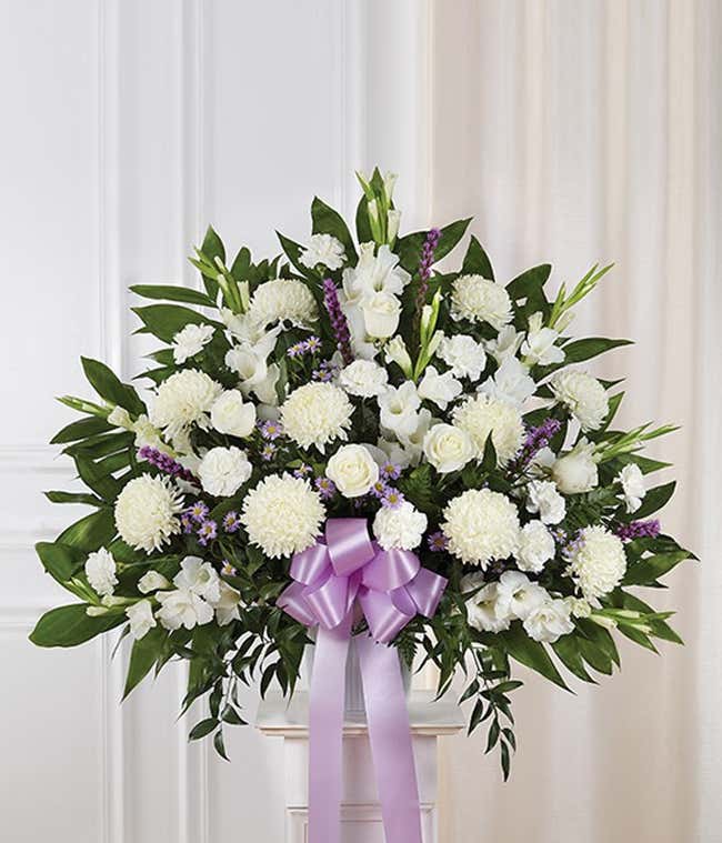 Sympathy basket with purple and white flowers