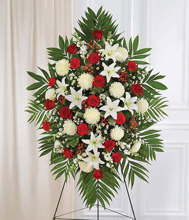 Funeral spray with red roses and carnations